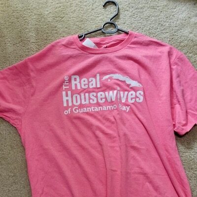 Square image of a t-shirt from Guantanamo Bay gift shop reading "The Real Housewives of Guantanamo Bay."