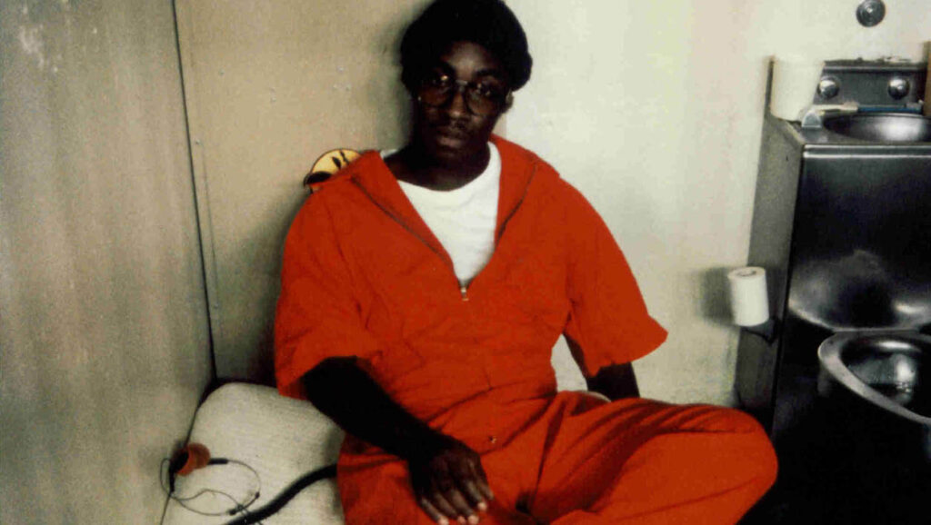 Image of Edward in a prison cell