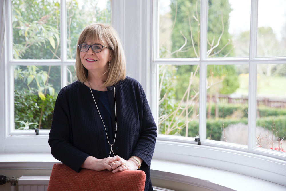 Image of Dame Elish Angiolini  in front of window